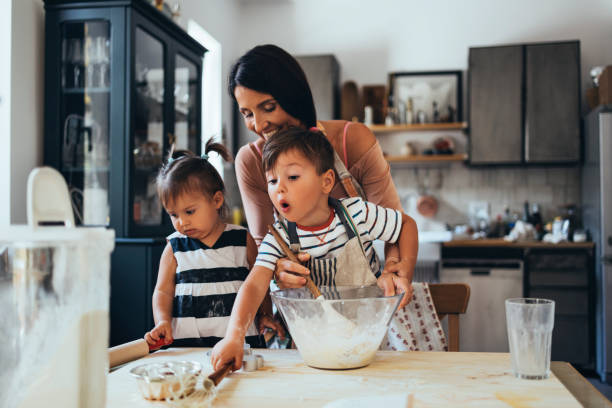 istock Family Making A Cake Together In The Kitchen 1435390541
