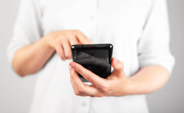 istock Woman hand clicking or swiping phone screen. Using smartphone in daily life for study, work, leisure. 1435390701
