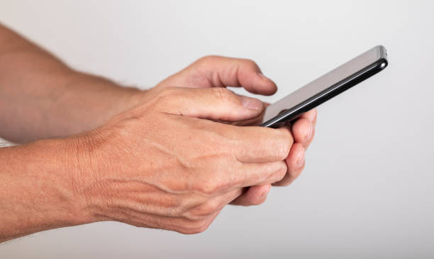 istock Man hands closeup texting message at phone. Male using messenger for chatting or surfing Internet. Telephone for online communication 1435390710