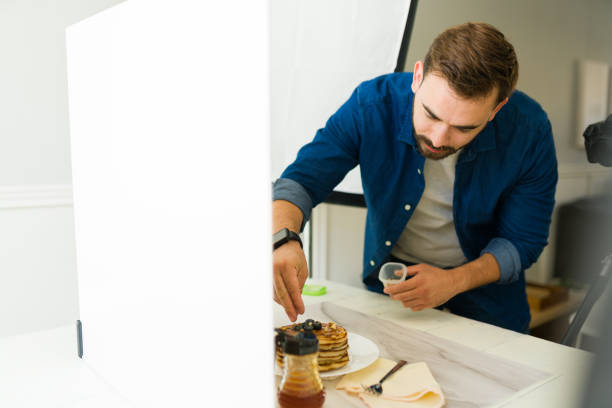 Young man doing food styling working as a photographer