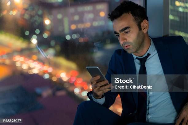 Tired Officer Working Night Shift In Office Officer Is Using The Phone Stock Photo - Download Image Now