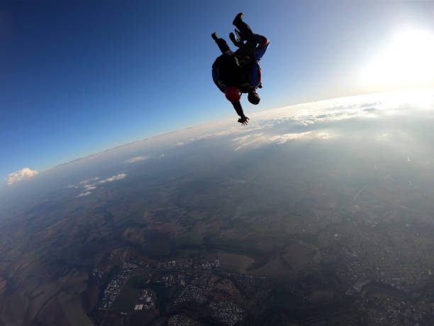istock Sky dive tandem friends at the sunset. 1435393122