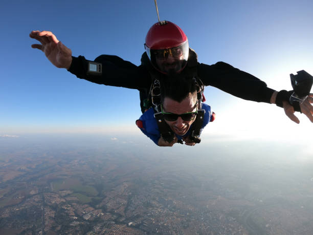 istock Sky dive tandem friends at the sunset. 1435393129