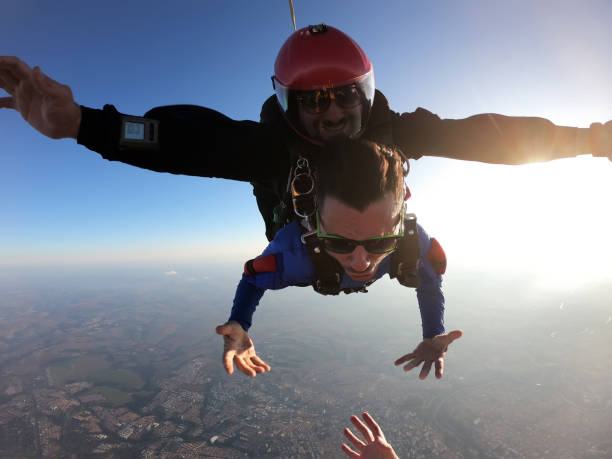 istock Sky dive tandem friends at the sunset. 1435393135