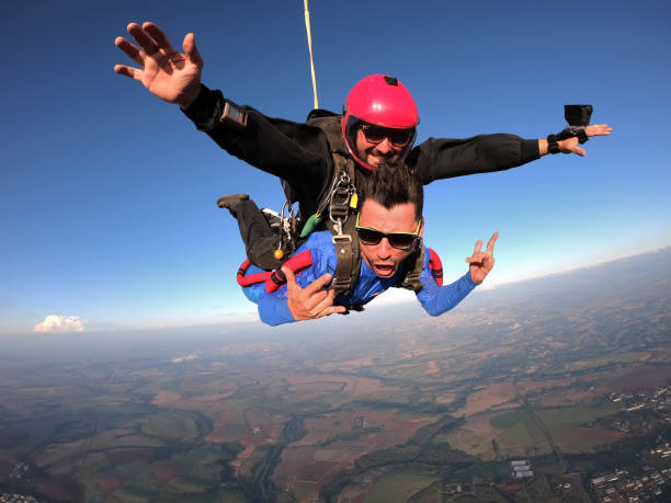 istock Sky dive tandem friends at the sunset. 1435393164