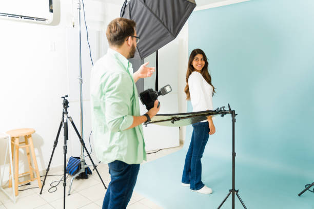 istock Happy model talking with a photographer at the studio 1435393309
