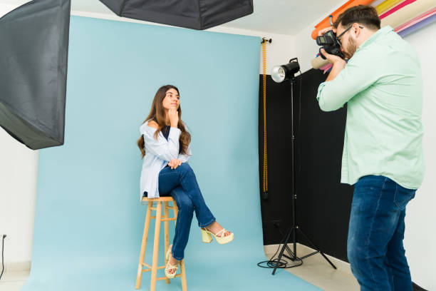 istock Model smiling while taking pictures with a photographer 1435393334