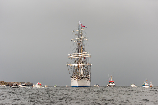Lindesnes, Norway - August 07 2021: Sail training vessel Statsraad Lehmkuhl greeted by an armada of small boats