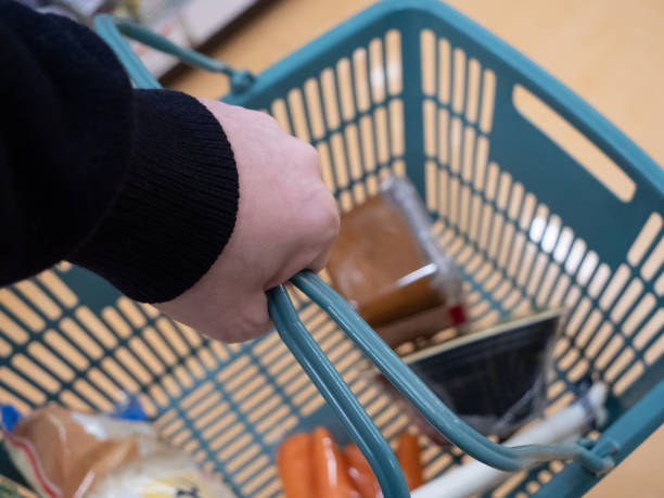 istock A young man's hand holding a shopping basket 1435397887