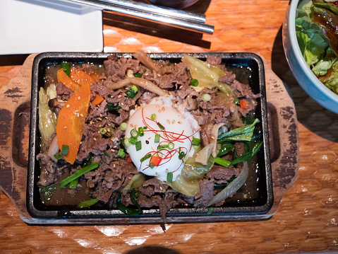 A Korean main course with beef and egg topping rice, ready to be eaten