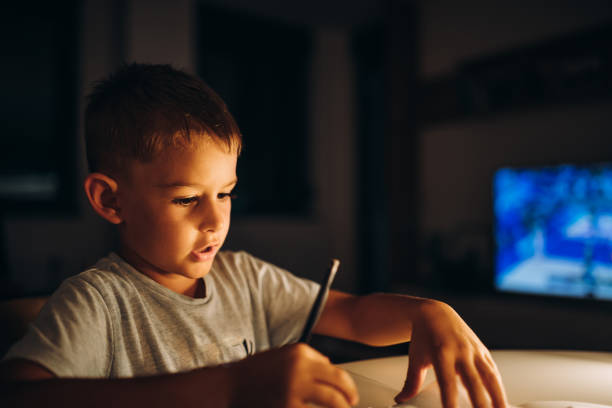 istock Child holding a pen and writing / drawing in low light 1435399152