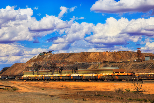 Freight train at Broken Hill train station in view of Line of Lode Junction mine - capital of Australian outback and mining industry.