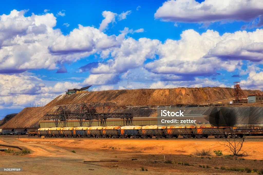 BH Freight Train mine dead tree Freight train at Broken Hill train station in view of Line of Lode Junction mine - capital of Australian outback and mining industry. Archaeology Stock Photo