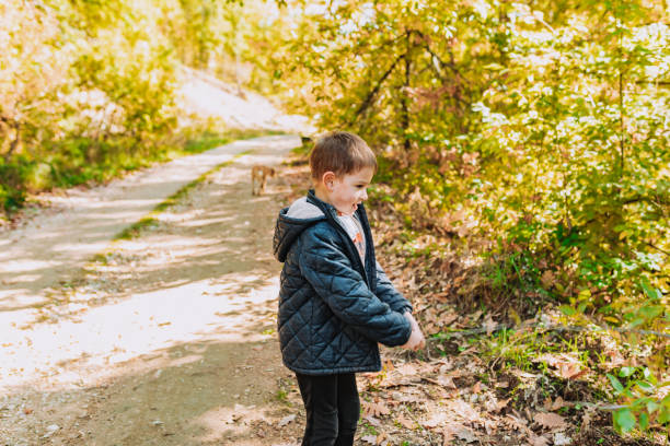 istock View of boy playing   in forrest on autumn 1435399397