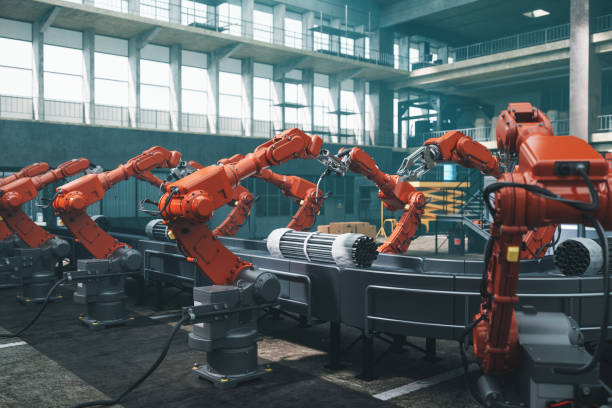 Robot Workers In Factory Industrial robots at the automated manufacturing factory assembly line. robot arm stock pictures, royalty-free photos & images