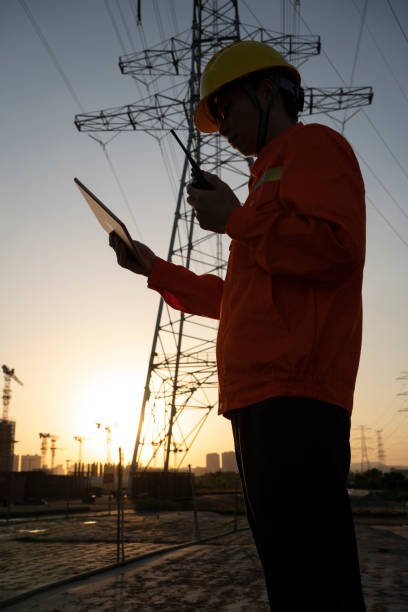 istock Power engineer working with tablet and walkie-talkie 1435421006