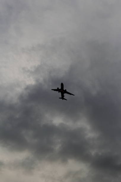 istock airplane over the dark stormy sky 1435422455