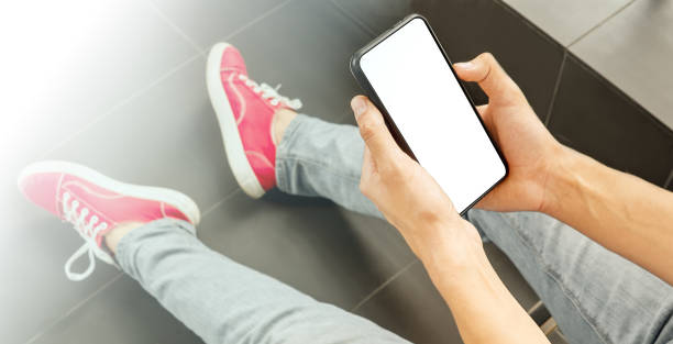 istock Smartphone with a white screen in male hands. selective focus 1435431232