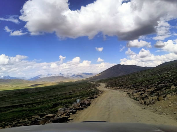 istock Dirt road with mountains in the background 1435432595