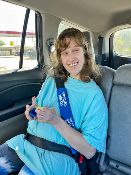 istock Intellectually disabled and autistic young adult riding in car 1435437376