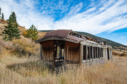 Old weathered passenger railroad car in ghost town in Colorado in western USA North America.