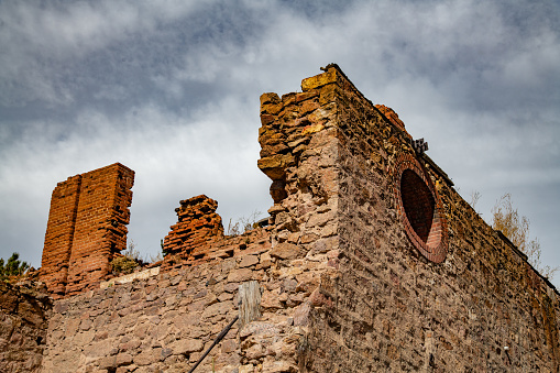 Old rough rugged stone wall or exterior structure from 1880s gold mining town in Colorado in the town of Victor in western USA of North America.