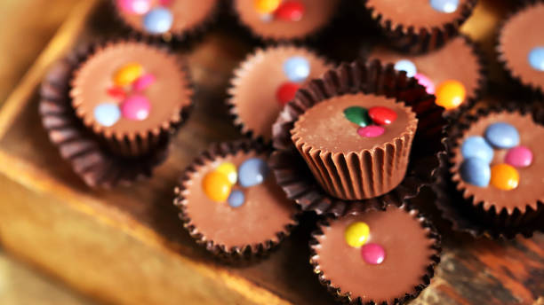 istock Selective focus. Macro. Small chocolate candies on a wooden board. 1435446716