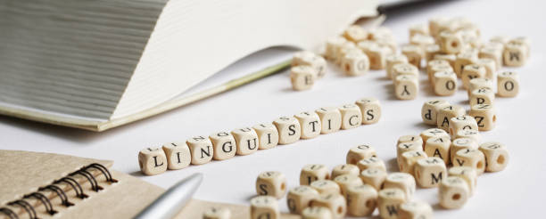 istock Word linguistics on a white background next to an open book, notepad, fountain pen and many letters. Concept of the study of the humanities and modern linguistic studies. Selective focus. 1435449477