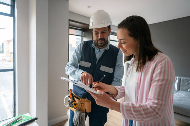 istock Woman remodeling her house and signing documents for the contractor 1435449558