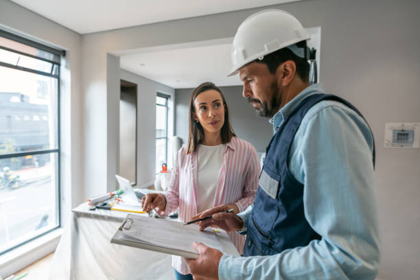 Woman talking to a contractor while remodeling her house