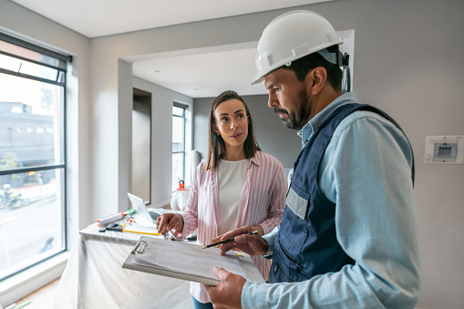 Latin American woman talking to a contractor while remodeling her house