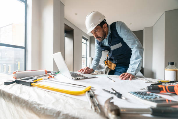istock Building contractor working in a house renovation and using his laptop 1435449613