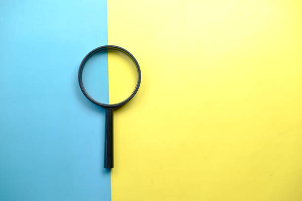 istock a magnifying glass on color background top view 1435450556