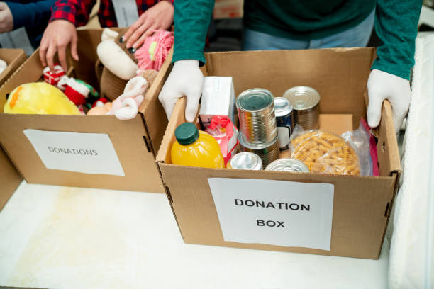 istock Unrecognizable volunteers receiving donations at a charitable foundation, organizing everything in boxes 1435451325