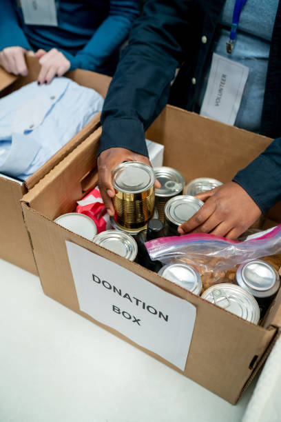 istock Close up of unrecognizable volunteers organizing donations in boxes 1435451339