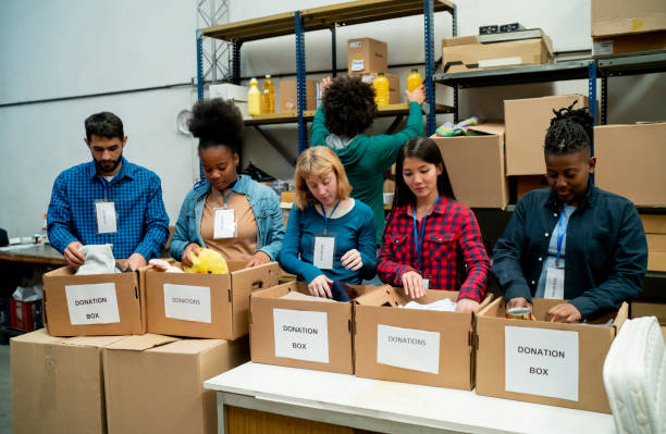 istock Diverse group of volunteers organizing donations in boxes at a charitable foundation 1435451346