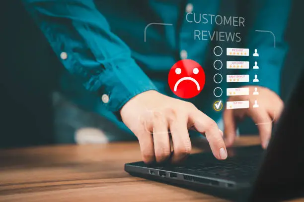 Photo of Unhappy man customer with sad emotion face on laptop. Bad review and service dislike poor quality, low rating, bad social media not good. Customer experience dissatisfied and testimonial concept.