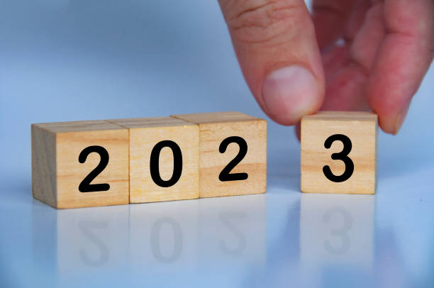 istock 2023 text on wooden blocks with hand background. New year concept 1435455523
