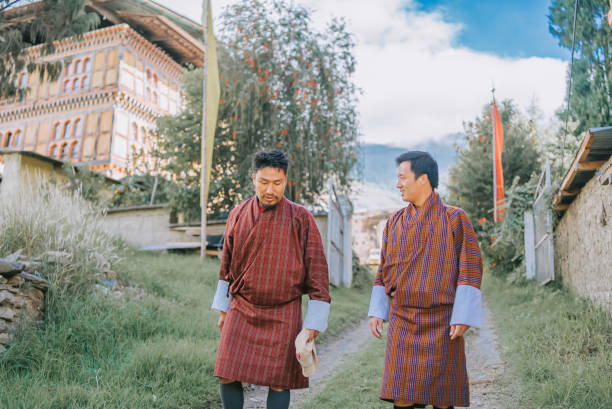 istock 2 Bhutanese Men walking in Thimphu street talking 1435456280