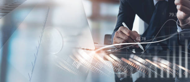 istock Business strategy, finance and investment concept. Businessman using tablet computer analyzing sales data with economic growth, financial graph chart report and coins 1435463069