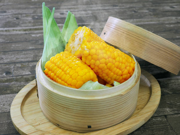 Steamed corn in a steamer basket
