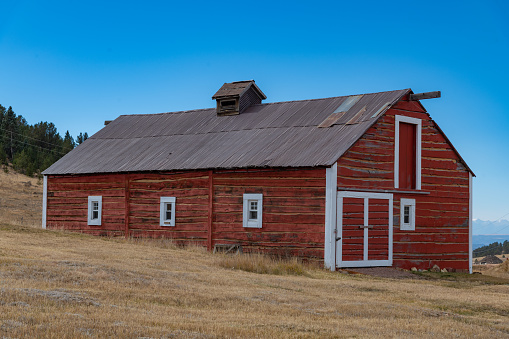 Old red farm and ranch barn in the Rocky Mountains of Colorado