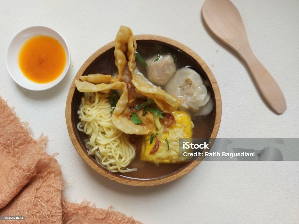 Poor bakwan on a bowl. Bakwan malang on a bowl. It is authentic food from malang city,indonesia. Concist of  noodle, fried meat, tofu, dumplings and meatballs. Isolated background in white Asia Stock Photo