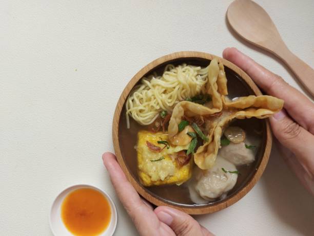 Poor bakwan on a bowl. Bakwan malang on a bowl. It is authentic food from malang city,indonesia. Concist of noodle, fried meat, tofu, dumplings and meatballs. Isolated background in white gorengan stock pictures, royalty-free photos & images