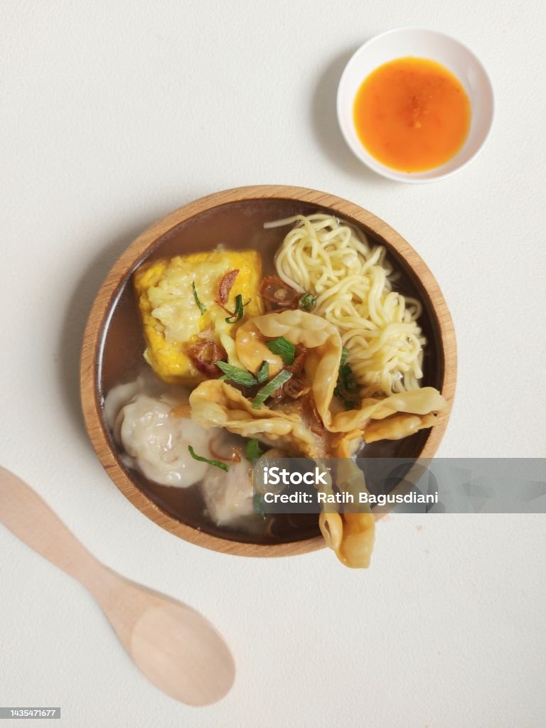 Poor bakwan on a bowl. Bakwan malang on a bowl. It is authentic food from malang city,indonesia. Concist of  noodle, fried meat, tofu, dumplings and meatballs. Isolated background in white Asia Stock Photo