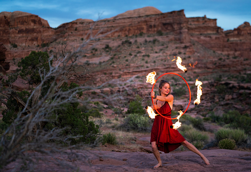 Fire dancer performing at dusk in Moab Park, USA