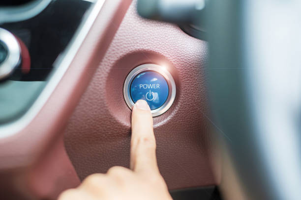 istock Finger press a car ignition button or START engine inside modern electric automobile. Keyless, change, strategy, vision, innovation and future concept 1435476959