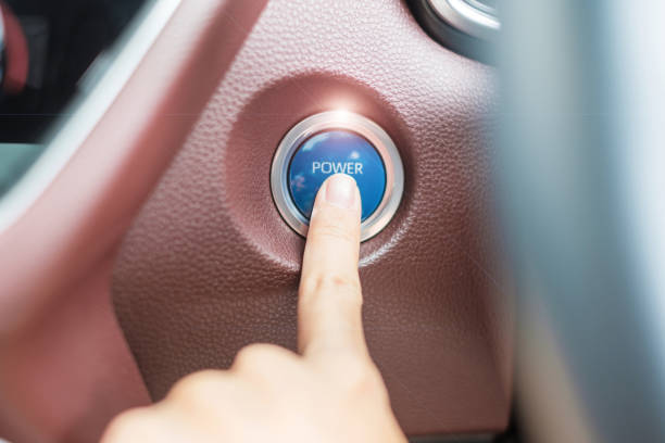 istock Finger press a car ignition button or START engine inside modern electric automobile. Keyless, change, strategy, vision, innovation and future concept 1435476975