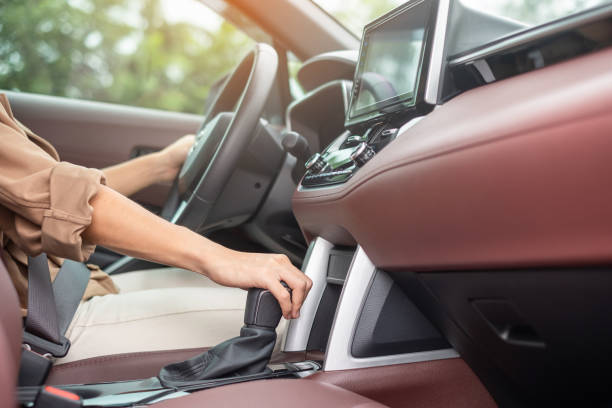istock woman driver stick shift transmission a car gear, hand controlling steering wheel during vehicle moving. Journey, trip and safety Transportation concepts 1435477100