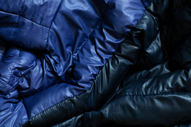 black puffed men's winter jacket as background, down jacket close up